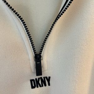 Cream colored DKNY sports pull over with black zipper and drawstrings brand new